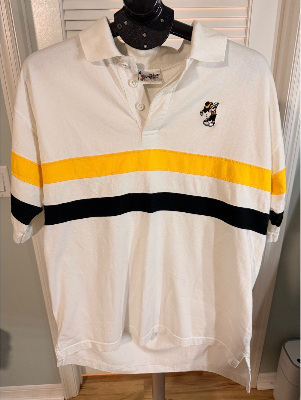 Disney white polo shirt with yellow and black stripe